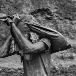 Sebastiao Salgado – Serra Pelada Gold Mine Brazil 1986 A worker carries a sack of dirt out of the mine